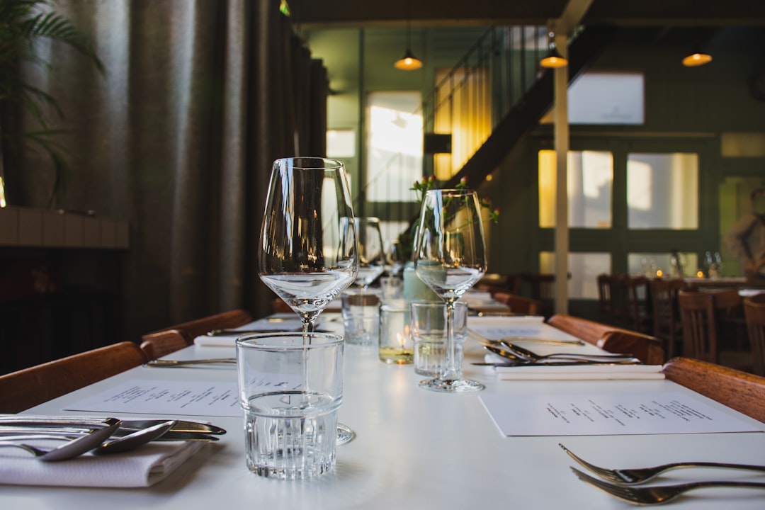 Restaurant table set with wine glasses and menus
